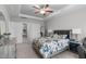 Relaxing main bedroom with neutral tones, a tray ceiling, and plenty of natural light at 74 Powderhorn Pt, Garner, NC 27529