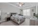 Comfortable main bedroom featuring a tray ceiling, fan, and cozy decor for relaxation at 74 Powderhorn Pt, Garner, NC 27529