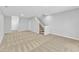 Spacious finished basement with carpeted floors, stairs and multiple access doors at 8415 Reedy Ridge Ln, Raleigh, NC 27613