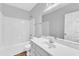 Bright bathroom with a white vanity, a large mirror, and a shower over the tub at 8415 Reedy Ridge Ln, Raleigh, NC 27613