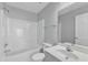 Bright bathroom with white fixtures including tub, toilet, vanity, and large mirror at 8415 Reedy Ridge Ln, Raleigh, NC 27613