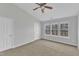 Bedroom with ceiling fan, carpeted flooring and 3 windows with a view of trees at 8415 Reedy Ridge Ln, Raleigh, NC 27613