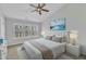 Bright bedroom with large windows, a ceiling fan and a calming beach-themed painting at 8415 Reedy Ridge Ln, Raleigh, NC 27613