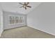 Bedroom with three windows, ceiling fan, carpeted flooring, and neutral paint at 8415 Reedy Ridge Ln, Raleigh, NC 27613