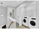 Hallway with laundry room featuring a washer and dryer, and access to other rooms at 8415 Reedy Ridge Ln, Raleigh, NC 27613