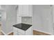 Modern kitchen peninsula with granite countertop and white cabinetry at 8415 Reedy Ridge Ln, Raleigh, NC 27613