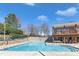 A community pool offers residents a large swimming area, lounge chairs and a covered patio at 8415 Reedy Ridge Ln, Raleigh, NC 27613