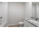 Bathroom with a granite countertop vanity, bathtub with white subway tile, and wood-look flooring at 903 Rhino Bnd, Oxford, NC 27565