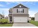 Charming two-story home with a two-car garage and manicured landscaping at 903 Rhino Bnd, Oxford, NC 27565