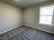 Cozy bedroom featuring neutral carpet, natural light from a window, and a clean, minimalist aesthetic at 91 Lotus Ave, Smithfield, NC 27577