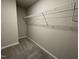 A simple closet features gray carpet and a wire shelf for optimal organization at 91 Lotus Ave, Smithfield, NC 27577