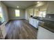 Open concept kitchen with granite countertops, stainless steel appliances, and a view to the living area at 91 Lotus Ave, Smithfield, NC 27577