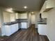 Well-equipped kitchen featuring ample storage, stainless steel appliances, gray backsplash, and wood-look flooring at 91 Lotus Ave, Smithfield, NC 27577
