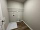 This laundry room features wood-look floors, a wire rack shelf and utility connections at 91 Lotus Ave, Smithfield, NC 27577