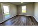 Bright room featuring wood-look flooring, a window with natural light, and a door leading to the exterior at 91 Lotus Ave, Smithfield, NC 27577