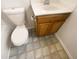 This bathroom features a vanity with wood cabinets and a matching tile floor at 910 Savin Lndg, Knightdale, NC 27545