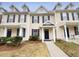 Inviting townhouse with blue shutters, a black door and small front yard at 910 Savin Lndg, Knightdale, NC 27545