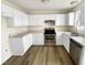 Bright kitchen featuring stainless steel appliances, white cabinets, and wooden floors at 910 Savin Lndg, Knightdale, NC 27545
