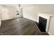 This living room features gorgeous wood floors and a black fireplace at 910 Savin Lndg, Knightdale, NC 27545
