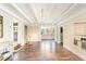 Spacious living room featuring hardwood floors, white wood-beamed ceilings and seamlessly connecting to other areas of the home at 1024 Tobacco Rd, Pittsboro, NC 27312