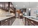 Spacious kitchen featuring dark wood cabinets, white countertops, and stainless steel appliances at 1025 Bender Ridge Dr, Morrisville, NC 27560