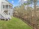This backyard has a black metal fence bordering the yard and a large grassy area at 112 Pointe Park Cir, Holly Springs, NC 27540