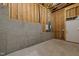 Unfinished basement area with visible framing, concrete walls, and flooring ready for customization at 112 Pointe Park Cir, Holly Springs, NC 27540