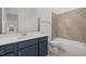 Stylish bathroom with a vanity, a modern mirror and a tiled shower-tub combo at 112 Pointe Park Cir, Holly Springs, NC 27540