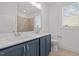 Bathroom featuring a double vanity with white countertop, a window, and toilet at 112 Pointe Park Cir, Holly Springs, NC 27540
