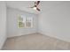 Bedroom with carpet floors, a window, white walls, and a ceiling fan at 112 Pointe Park Cir, Holly Springs, NC 27540