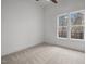 This bedroom features plush carpeting, a ceiling fan, and natural light from double windows at 112 Pointe Park Cir, Holly Springs, NC 27540