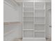 White walk-in closet featuring white shelves and wooden racks, providing ample storage space at 112 Pointe Park Cir, Holly Springs, NC 27540
