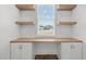 Bright home office features a built-in desk with open shelves and a window with blinds at 112 Pointe Park Cir, Holly Springs, NC 27540