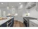 Modern kitchen features stainless steel appliances, granite countertops and white cabinets at 112 Pointe Park Cir, Holly Springs, NC 27540