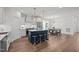 Open-concept kitchen and dining area with a center island and modern lighting fixture at 112 Pointe Park Cir, Holly Springs, NC 27540