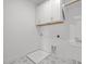 Bright laundry room featuring patterned tile flooring, white cabinets, and utility sink at 112 Pointe Park Cir, Holly Springs, NC 27540
