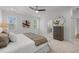 Comfortable main bedroom featuring a plush bed, dresser, and natural light from two windows at 112 Pointe Park Cir, Holly Springs, NC 27540