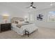 Serene main bedroom with a ceiling fan, bench seat, and sophisticated decor at 112 Pointe Park Cir, Holly Springs, NC 27540