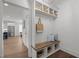 The mudroom features a bench seat with storage, overhead basket storage, and coat hooks at 112 Pointe Park Cir, Holly Springs, NC 27540