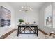 Bright home office featuring modern lighting, hardwood floors, and a stylish work space at 112 Pointe Park Cir, Holly Springs, NC 27540