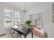 Well-lit home office featuring a large window, stylish lighting, and a cozy seating area at 112 Pointe Park Cir, Holly Springs, NC 27540