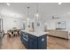 Open concept kitchen, dining room and living room with hardwood floors at 112 Pointe Park Cir, Holly Springs, NC 27540