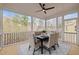 Inviting screened porch dining area with scenic views, comfortable seating, and neutral decor at 112 Pointe Park Cir, Holly Springs, NC 27540