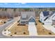 Aerial view of a two-story home with a two-car garage, front porch, driveway, and nicely landscaped front yard at 112 Sire Ct, Holly Springs, NC 27540