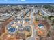 A beautiful aerial view of a neighborhood with a community pool in a suburban area with mature trees at 112 Sire Ct, Holly Springs, NC 27540