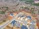 Aerial view of several homes in a neighborhood surrounded by woods and some construction at 112 Sire Ct, Holly Springs, NC 27540
