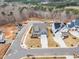 Aerial view of a blue home featuring landscaping, a driveway, and proximity to lush woodlands at 112 Sire Ct, Holly Springs, NC 27540