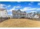 View of a charming gray two-story home with a screened porch and a well-maintained, fenced backyard at 112 Sire Ct, Holly Springs, NC 27540