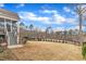 Expansive backyard featuring a manicured lawn, patio, and treelined perimeter for added privacy at 112 Sire Ct, Holly Springs, NC 27540