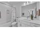 Bright bathroom features a shower with a flower curtain, a toilet, and a vanity with white cabinets at 112 Sire Ct, Holly Springs, NC 27540